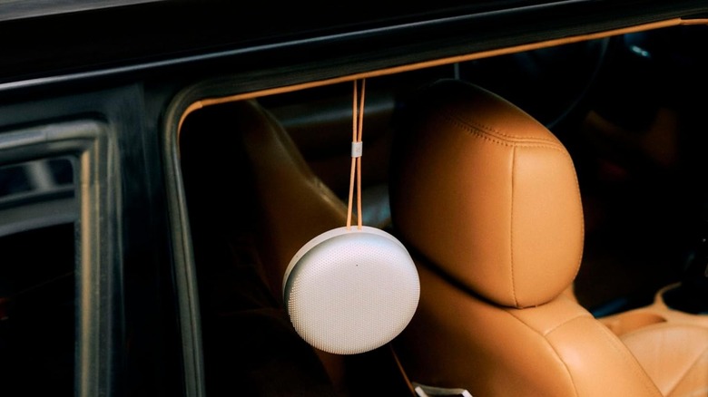 A Beosound A1 hung to a car