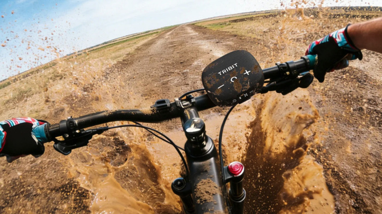 The Tribit Stormbox Micro 3 mounted to a dirt bike handle.