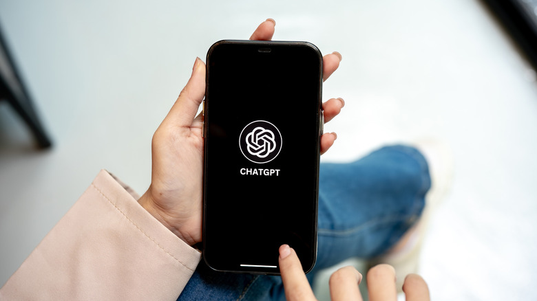A woman using ChatGPT on an iPhone.