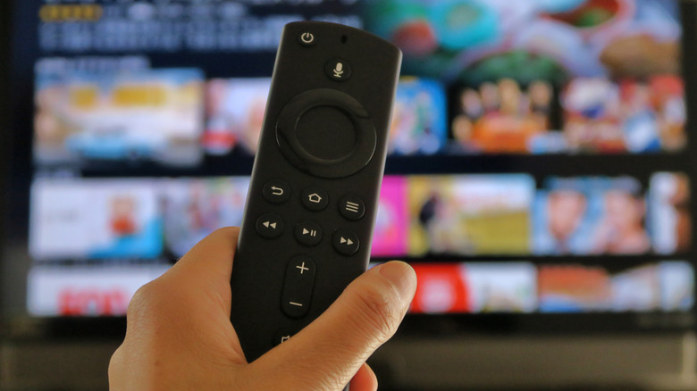 amazon fire tv stick remote with a tv in the background
