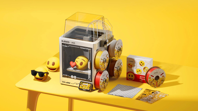 ELEGOO Centauri Carbon 2 Combo 3D printer with emoji-themed filament spools and printed emoji models.