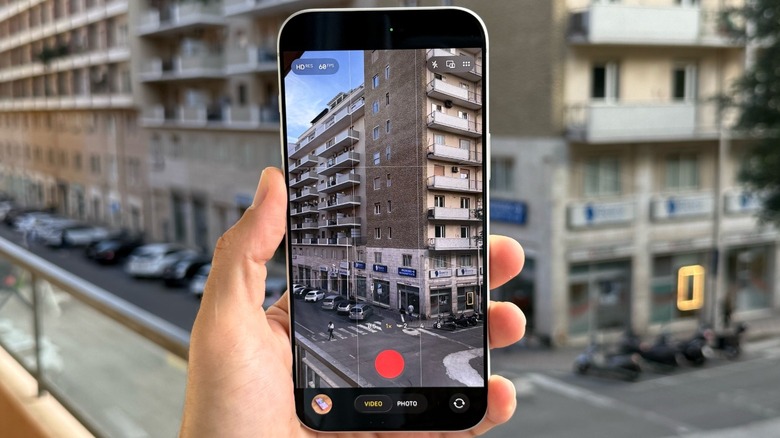 A person holding an iPhone 17 Pro Max with the camera open
