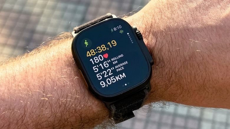 An Apple Watch displaying a running workout with Workout Buddy on