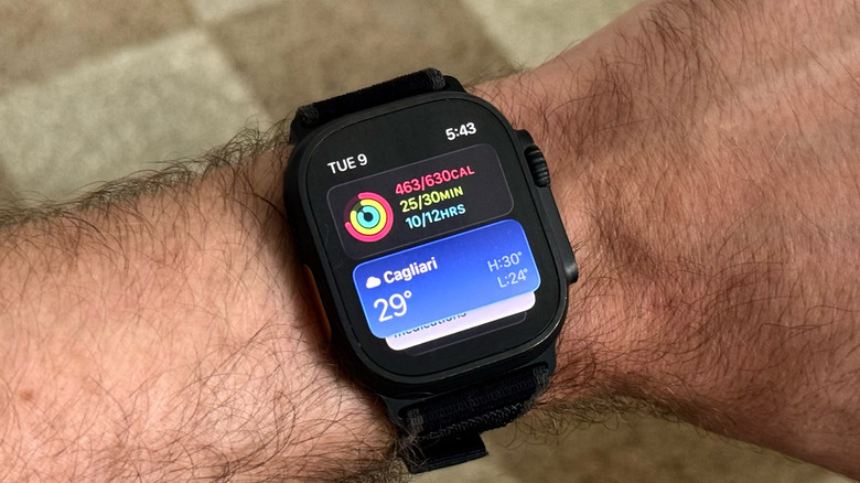 A man's arm with an Apple Watch Ultra 2 displaying the Smart Stack