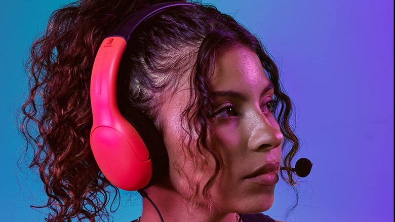 A woman wearing the PDP Nintendo Switch gaming headset.