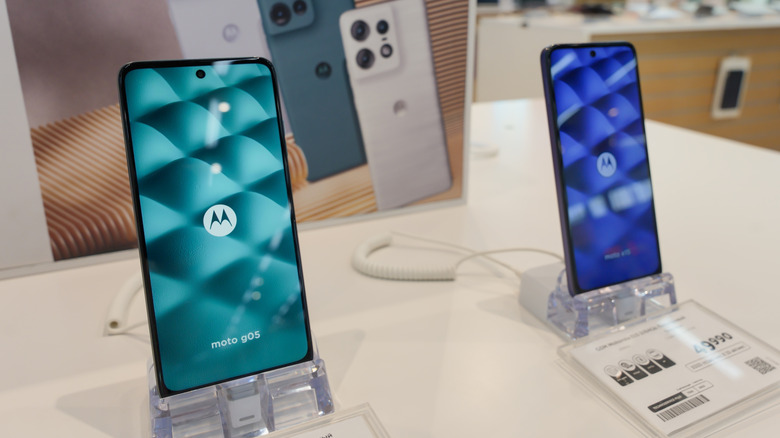 Motorola phones displayed on stands in an electronics store.