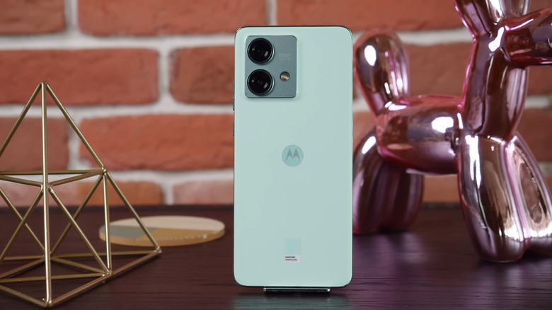 Motorola phone displayed on a stand with its rear cameras facing forward.