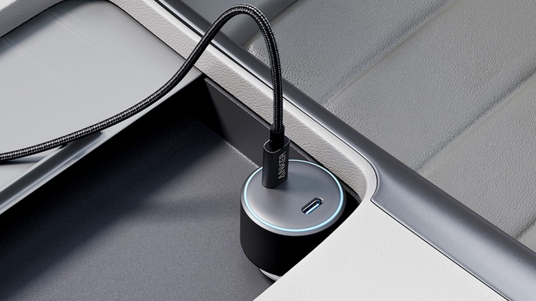 An Anker Type-C 60W Fast Charging Cable plugged into a USB port in a charging adapter within a vehicle