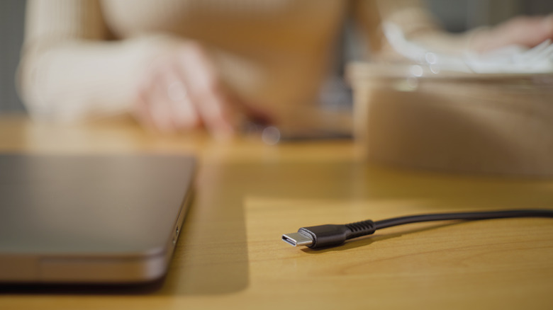 USB-C cable on table with laptop