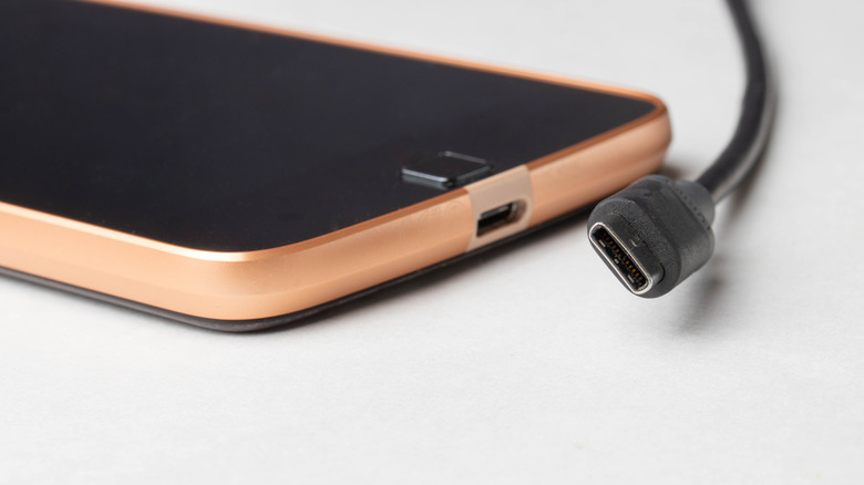 An Android smartphone and a USB-C charging cable.