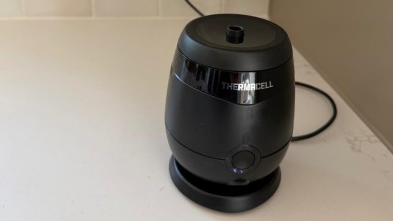 Black Thermacell E-Series Rechargeable Mosquito Repeller on a countertop.