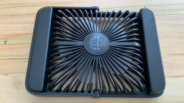 Black Warmco 20000mAh Battery Powered Fan placed upside down on a table.