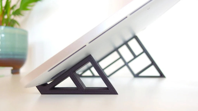 A pair of geometric stands for a laptop