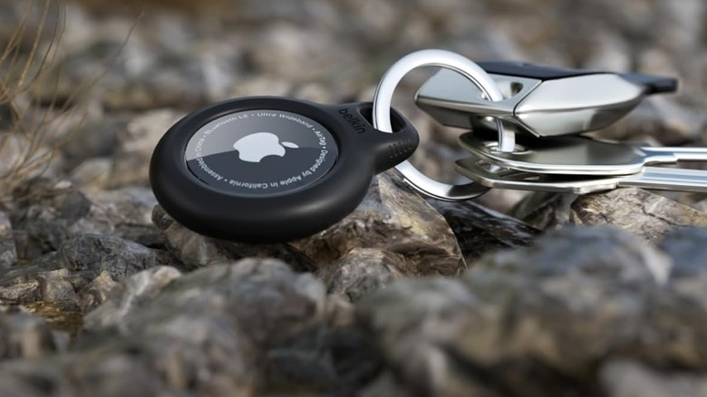 The Belkin AirTag Holder with Key Ring on a rocky surface