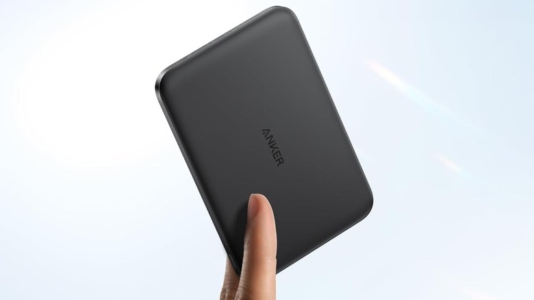 Close-up of two fingers holding the Anker Nano Power Bank