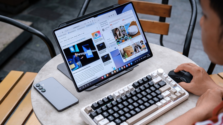 Samsung Galaxy Tab S11 Ultra on a desk, connected to an external keyboard and mouse.