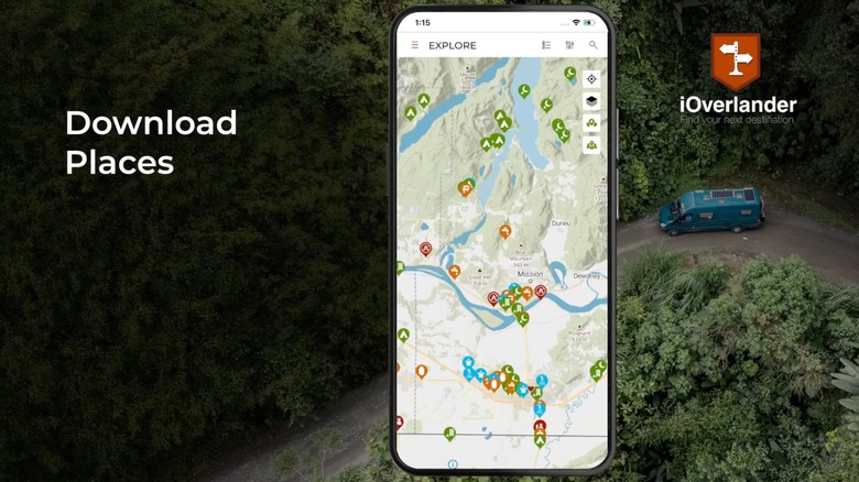 A still from a promotional video for the iOverlander app for Android, the image shows a vehicle trail in the background as a cellphone displays a map containing trail information