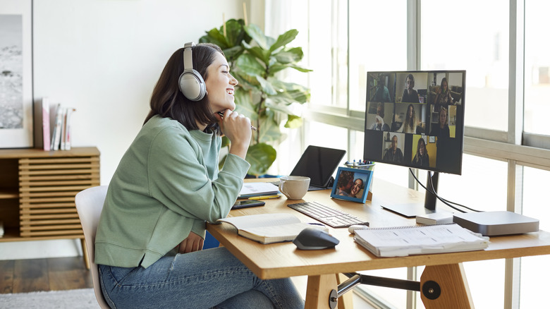 woman sitting at desk and talking on a video call