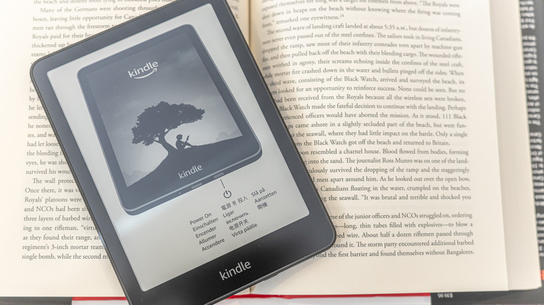 Kindle Paperwhite laying on top of open book