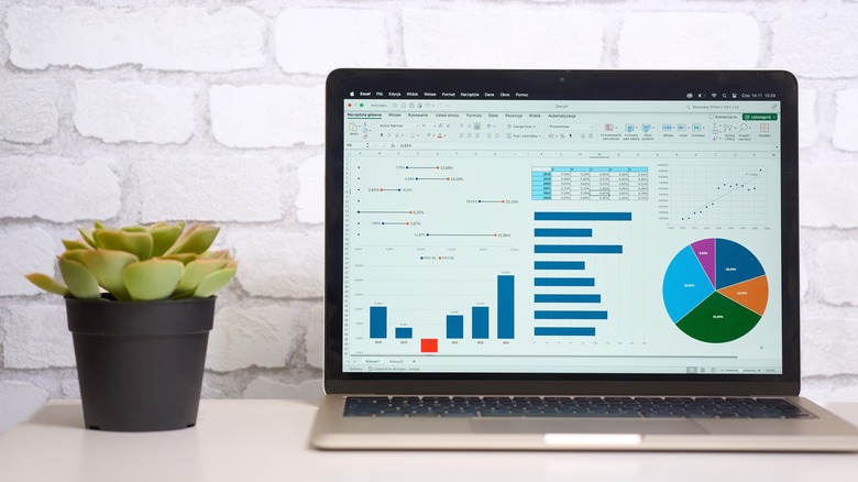 a MacBook showing a data analytics screen
