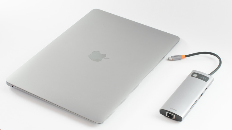Macbook with USB hub next to it
