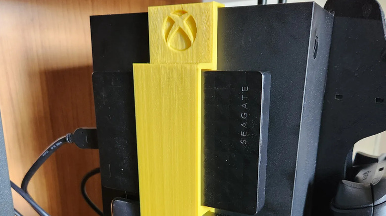 Xbox Series X with a 3D-printed HDD holder and Seagate external drive attached.