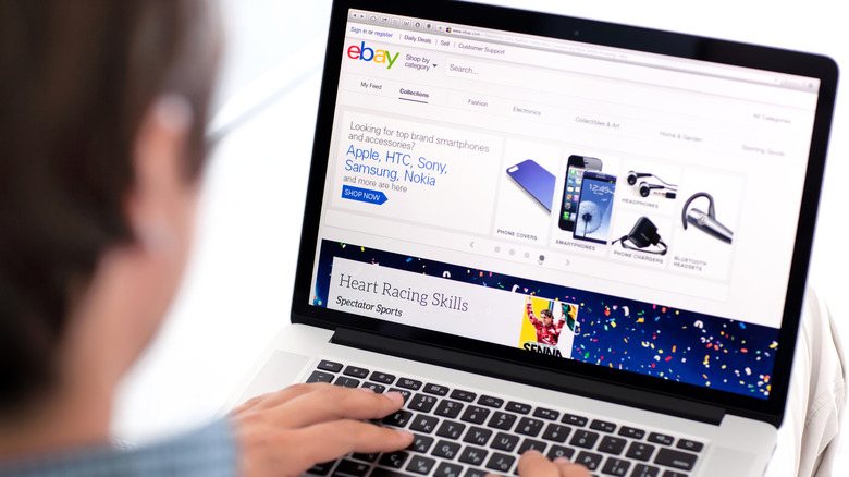 A person browsing eBay on a laptop.