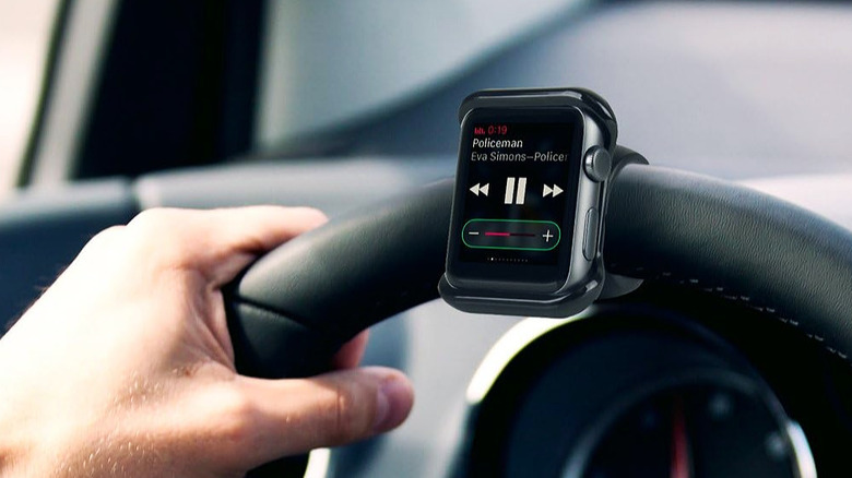 A smartwatch mounted to a steering wheel.