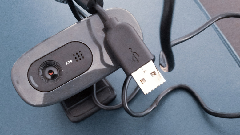 A slightly dusty USB webcam on a table.