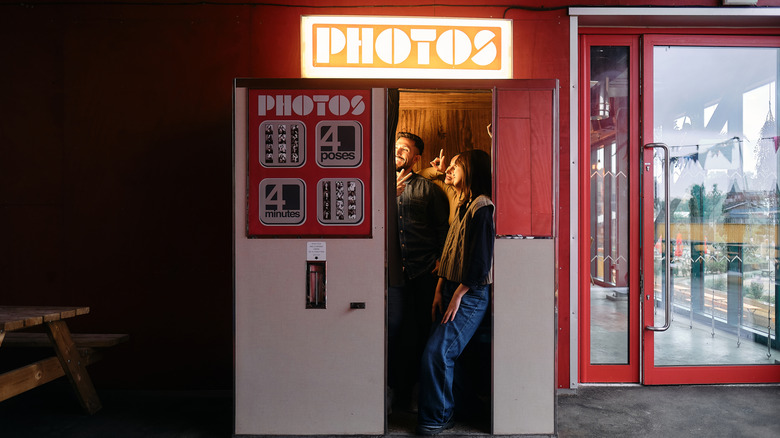 Several people posing in a photo booth.