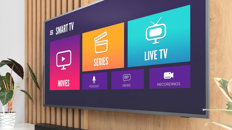 close-up of a smart tvv mounted on a wall showing home screen options