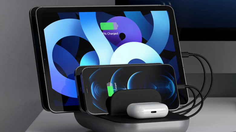 An iPad, iPhone, and AirPods case in a Satechi multi-device charging station