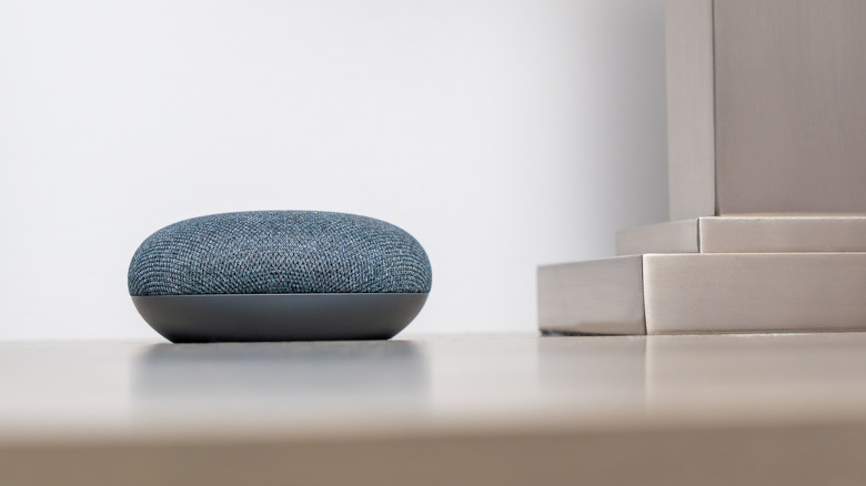 A gray Google Home Speaker on a table