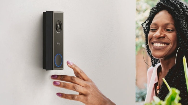Close-up of a person ringing the Eufy Video Doorbell C31