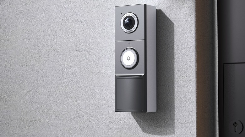 The TP-Link Tapo D225 video doorbell mounted on a wall outside a house