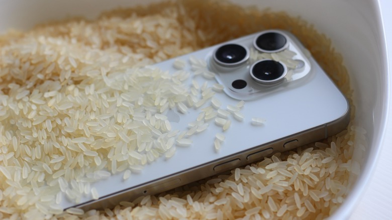 Smartphone placed in a bowl of rice