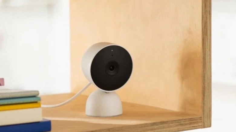 The Google Nest Cam security camera on a bookshelf.