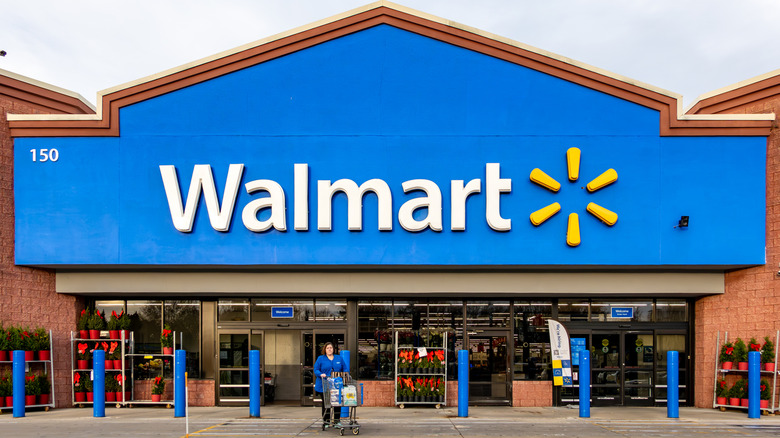 The entrance of a Walmart store with the company's logo.