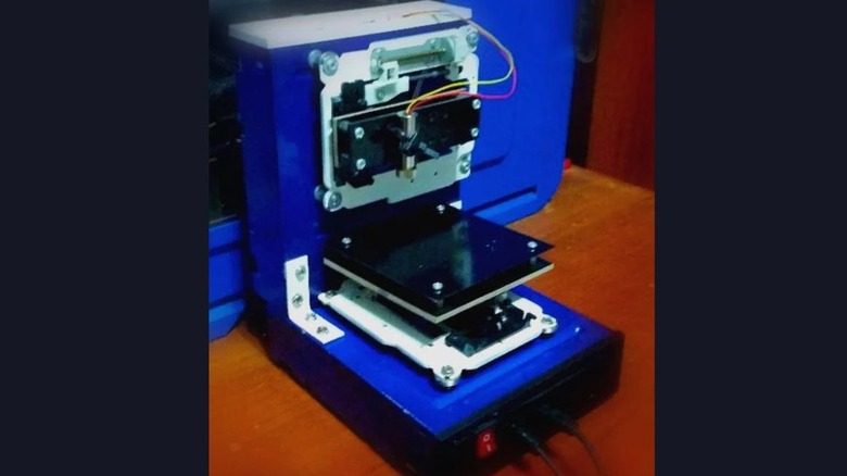 Image of an old DVD player repurposed to serve as a laser engraver.