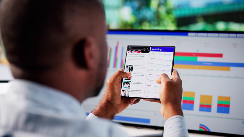A person running two apps on an Android foldable phone.