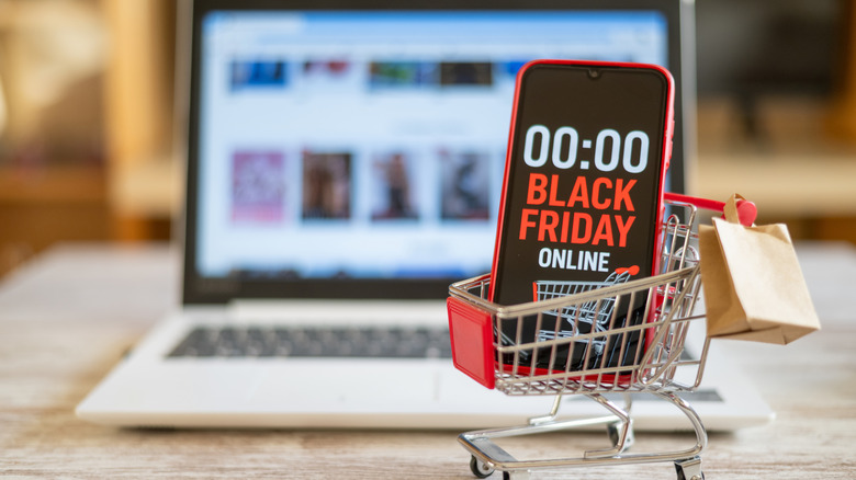 Shopping cart with a phone displaying Black Friday countdown