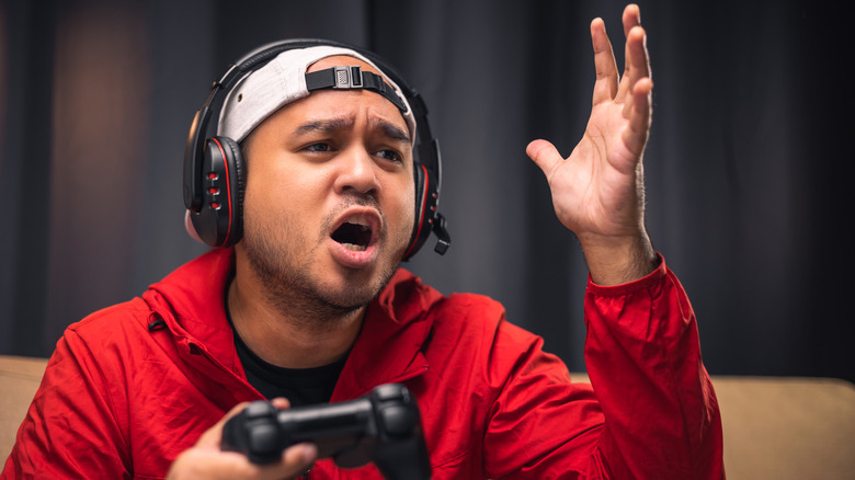 angry gamer holding game controller