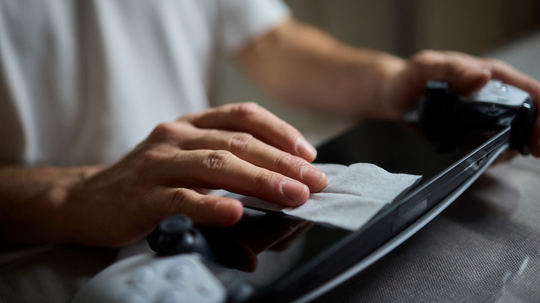person cleaning their gaming gear