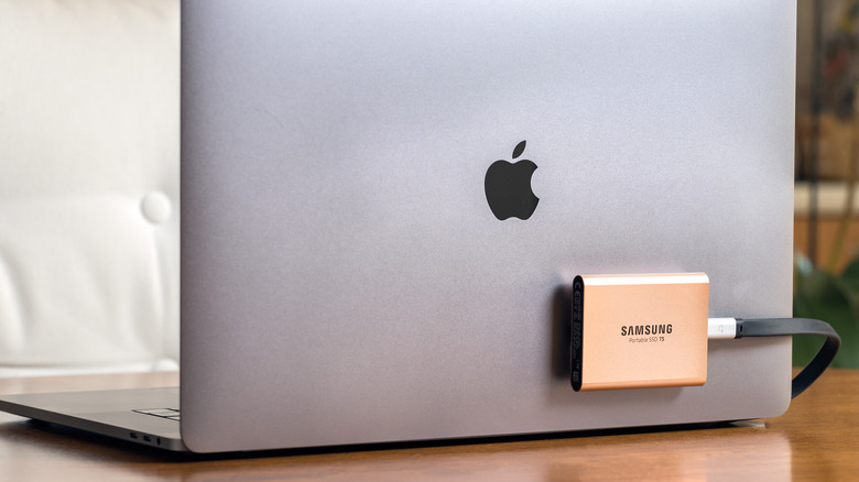 A Samsung portable SSD attached and connected to a MacBook.