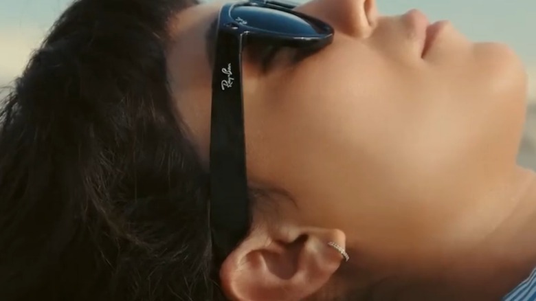 A woman listening to music on Ray-Ban Meta smart glasses.