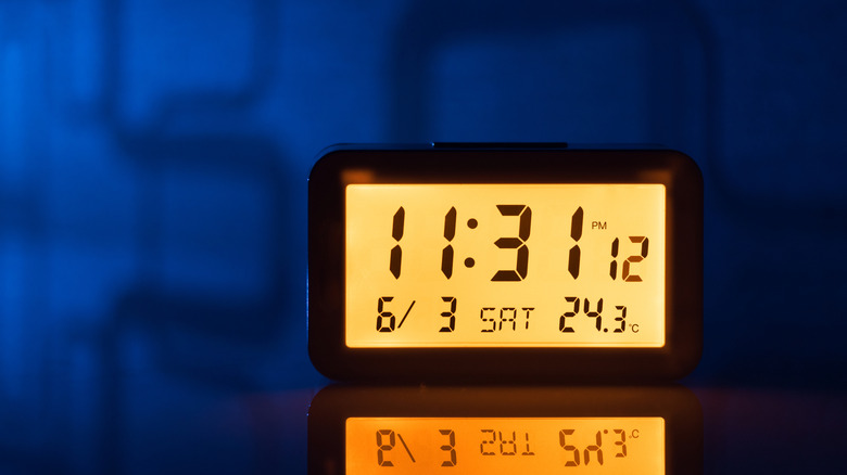 Digital alarm clock on night stand