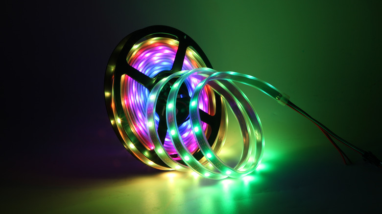 RGB lighting strip coiled around holder and illuminated.