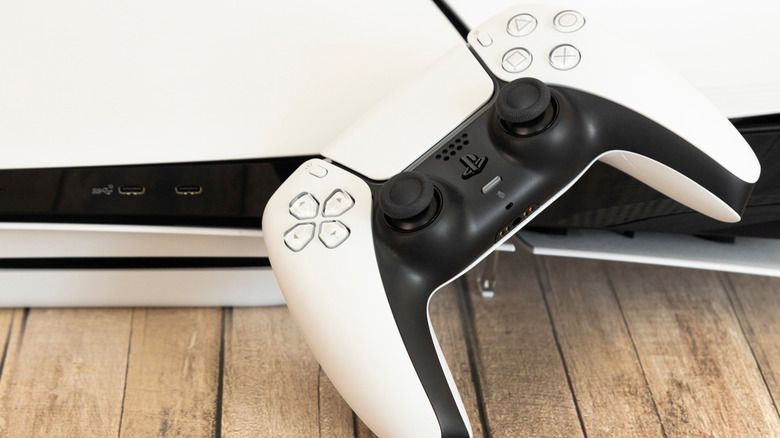 PlayStation 5 console with DualSense controller and USB ports visible.