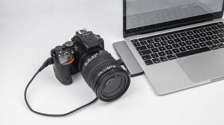 A DSLR camera tethered to a laptop via USB cable