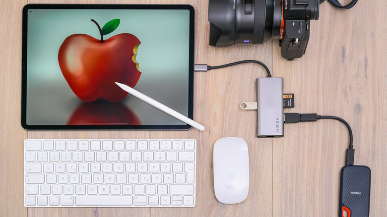 An iPad Pro connected to a USB-C hub with Apple Magic Keyboard and Mouse on the table